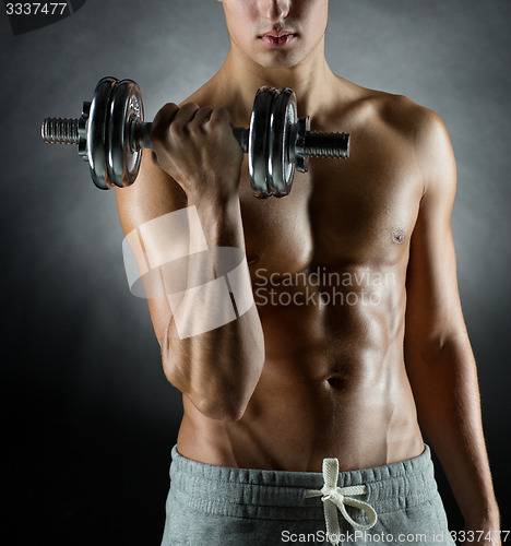 Image of young man with dumbbell