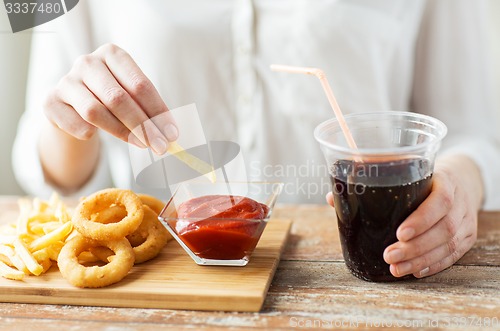 Image of close up of woman with snacks and cocacola