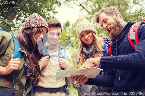 Image of group of smiling friends with backpacks hiking