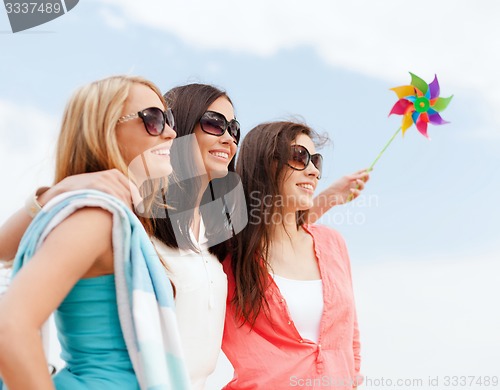 Image of girls with windmill toy on the beach