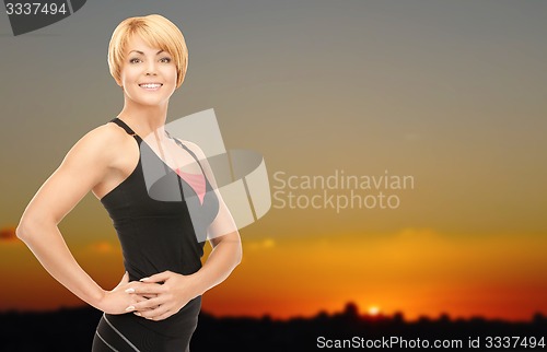 Image of happy woman outdoors over sunset skyline