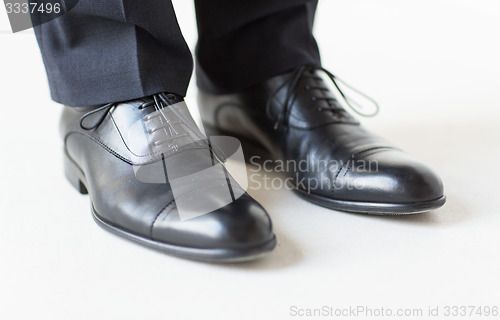 Image of close up of man legs in elegant shoes with laces