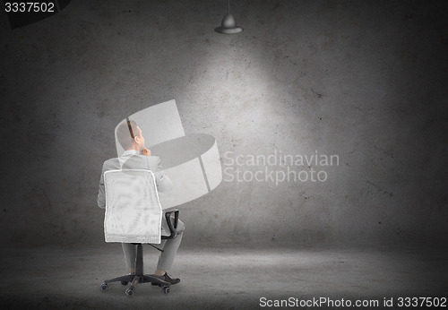 Image of businessman in office chair over white board