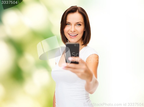 Image of woman taking selfie with smartphone