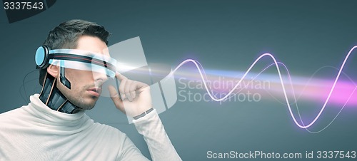 Image of man with futuristic 3d glasses and sensors