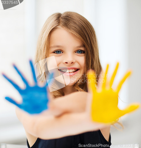 Image of girl showing painted hands