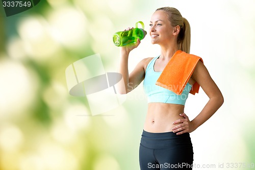 Image of woman with bottle of water and towel