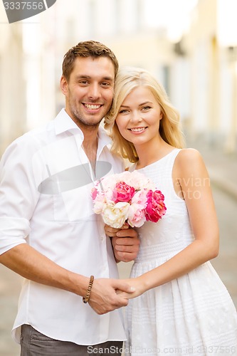 Image of couple with flowers in the city