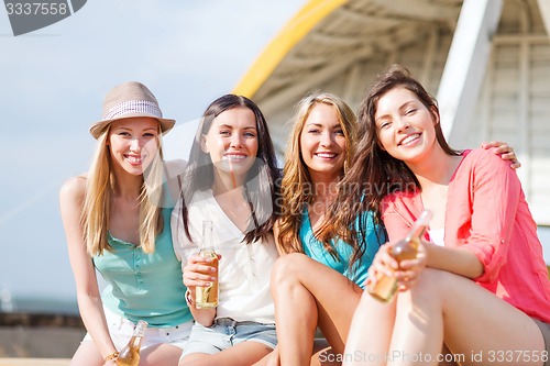 Image of girls with drinks on the beach