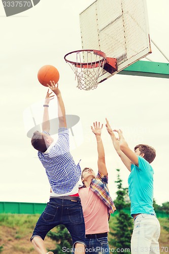 Image of group of teenagers playing basketball