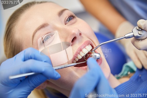 Image of close up of dentist treating female patient teeth