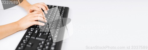 Image of student girls hands typing on keyboard