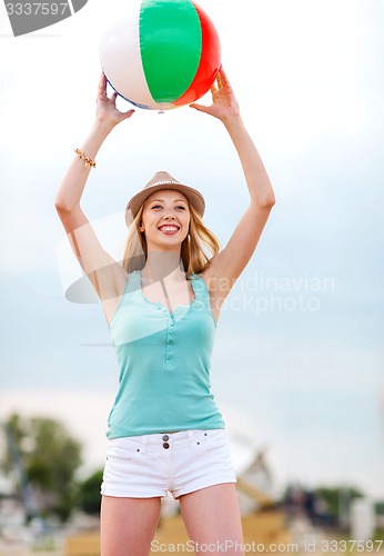 Image of girl playing ball on the beach