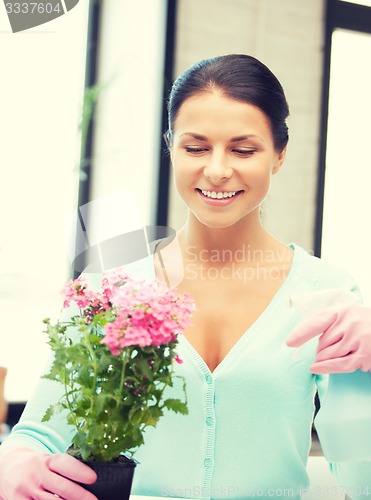 Image of lovely housewife with flower