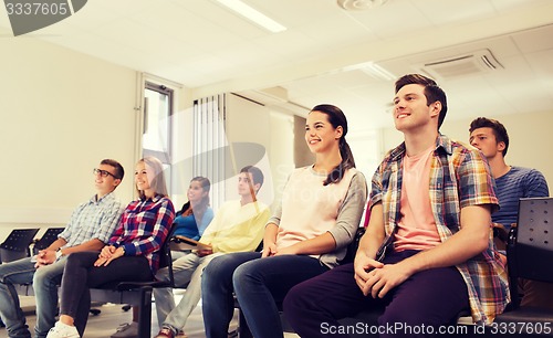 Image of group of smiling students in lecture hall