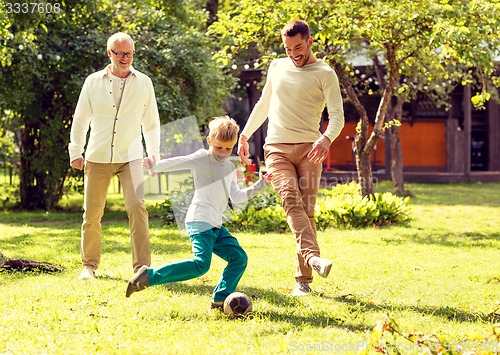 Image of happy family playing football outdoors