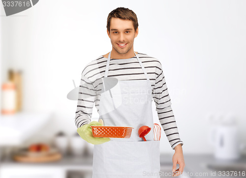 Image of happy man or cook with baking and kitchenware