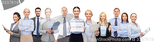 Image of group of happy businesspeople holding contract