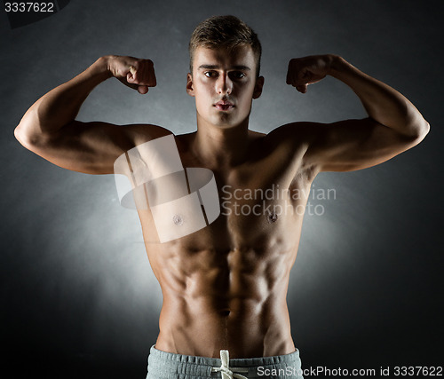 Image of young man showing biceps