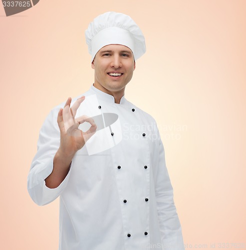 Image of happy male chef cook showing ok sign