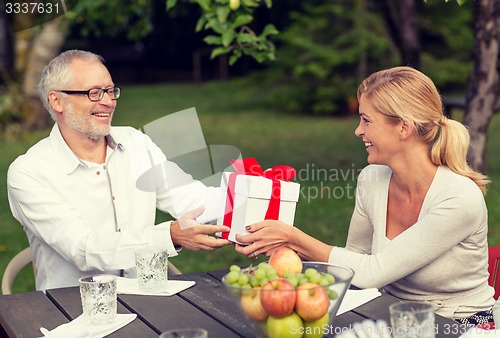 Image of happy family having holiday dinner outdoors