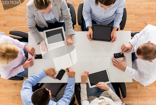 Image of business team with smartphones and tablet pc