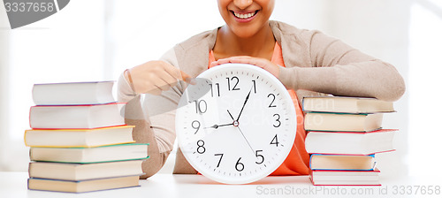 Image of attractive woman with white clock