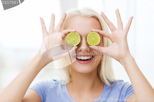 Image of happy woman having fun covering eyes with lime