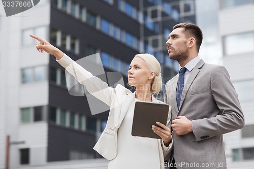 Image of serious businessmen with tablet pc outdoors