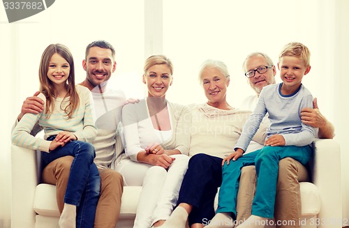 Image of happy family sitting on couch at home