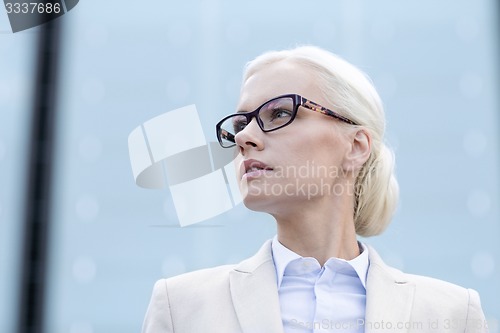 Image of young businesswoman over office building
