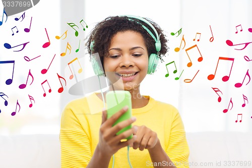 Image of happy african woman with smartphone and headphones