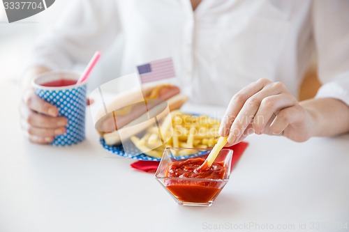 Image of close up of woman eating on american food