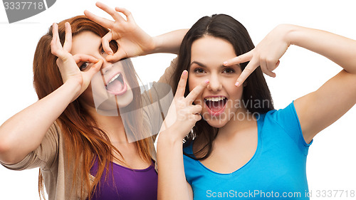 Image of two young teenagers making faces
