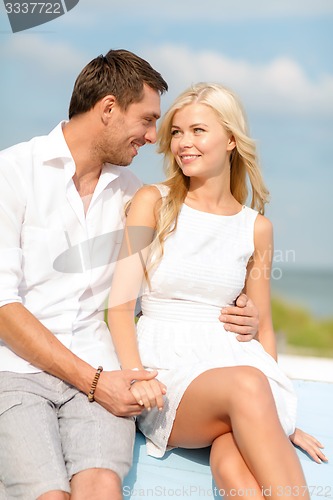 Image of smiling couple at sea side