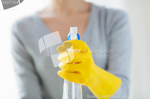 Image of close up of happy woman with cleanser spraying