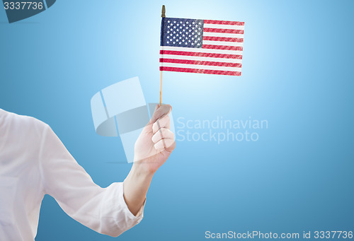 Image of close up of woman holding american flag in hand