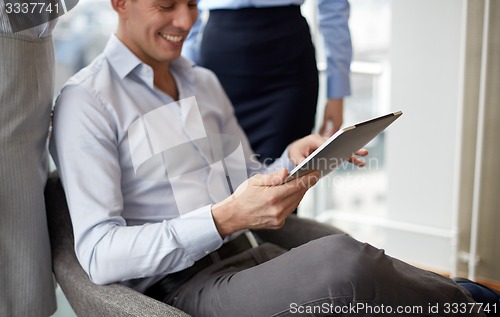 Image of business team working with tablet pc in office