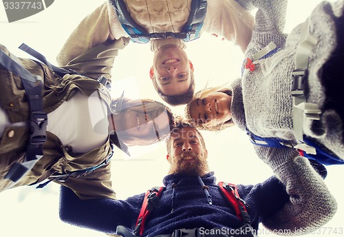 Image of group of smiling friends with backpacks hiking