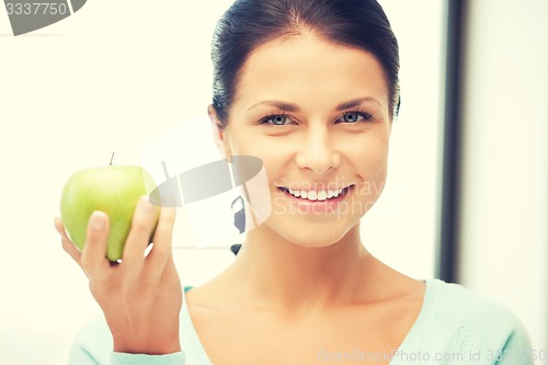 Image of lovely housewife with green apple