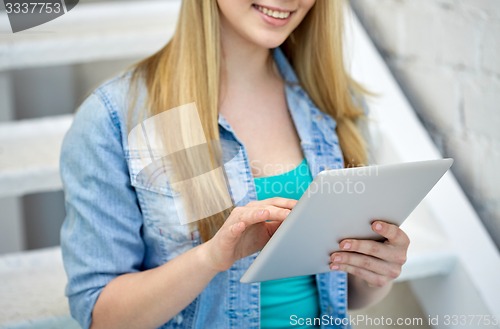 Image of close up of female hands with tablet pc on stairs