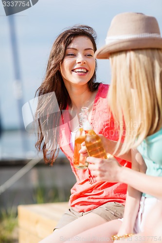 Image of girls with drinks on the beach