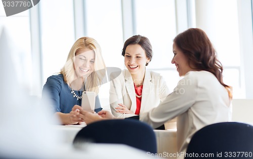 Image of happy women with smartphone at restaurant