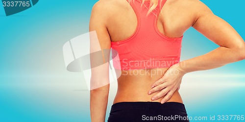 Image of close up of sporty woman touching her back