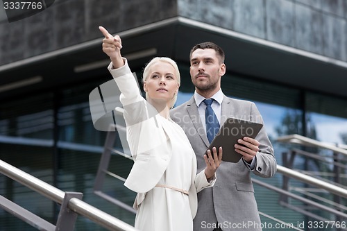 Image of serious businessmen with tablet pc outdoors