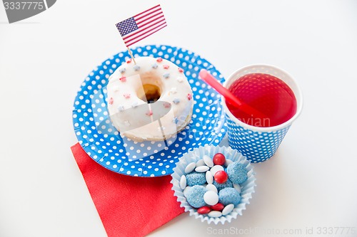 Image of donut with juice and candies on independence day