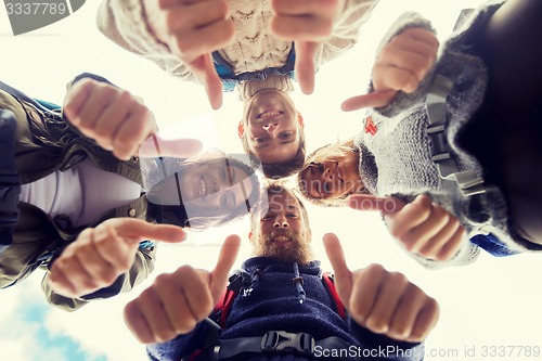 Image of group of smiling friends with backpacks hiking