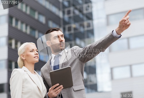 Image of serious businessmen with tablet pc outdoors