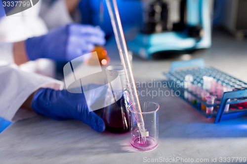 Image of close up of scientists making test in lab