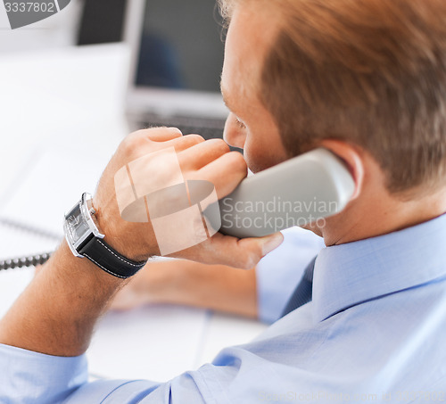 Image of handsome businessman talking on the phone